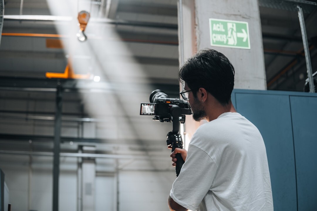 Camera operator adjusting a studio broadcast camera during a transition