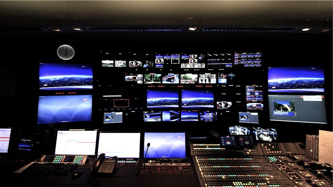 Broadcast control room with monitors showing live camera feeds